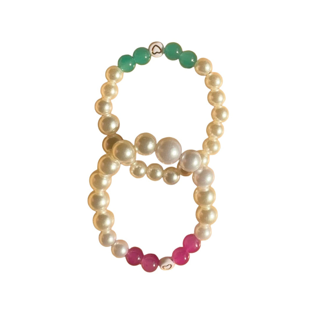 Pearly bracelet duo on white background