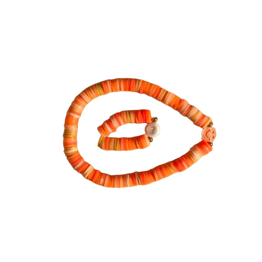 Pumpkin bracelet duo on white background